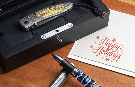 Close-up of a handcrafted knife, pen, and 