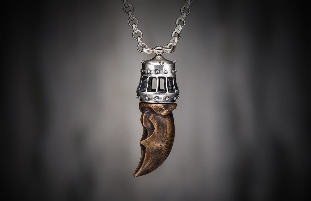 Bronze King's Claw pendant with a studded silver cap, featuring rectangular cutouts, suspended from a matching silver chain.