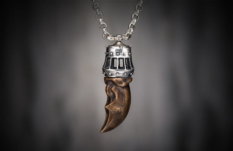 Bronze King's Claw pendant with a studded silver cap, featuring rectangular cutouts, suspended from a matching silver chain.