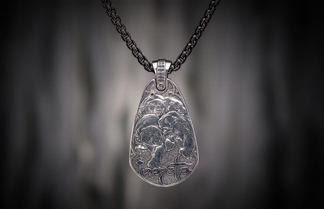 Oxidized silver pendant featuring four engraved bears, 'RAVE' text, and a cross symbol, hanging from a dark chain.