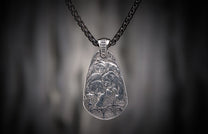 Oxidized silver pendant featuring four engraved bears, 'RAVE' text, and a cross symbol, hanging from a dark chain.