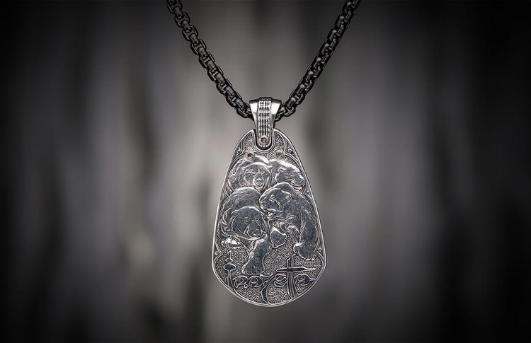 Oxidized silver pendant featuring four engraved bears, 'RAVE' text, and a cross symbol, hanging from a dark chain.
