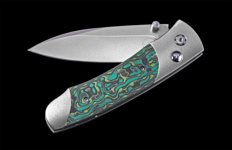 Foldable knife with a decorative handle on a black background