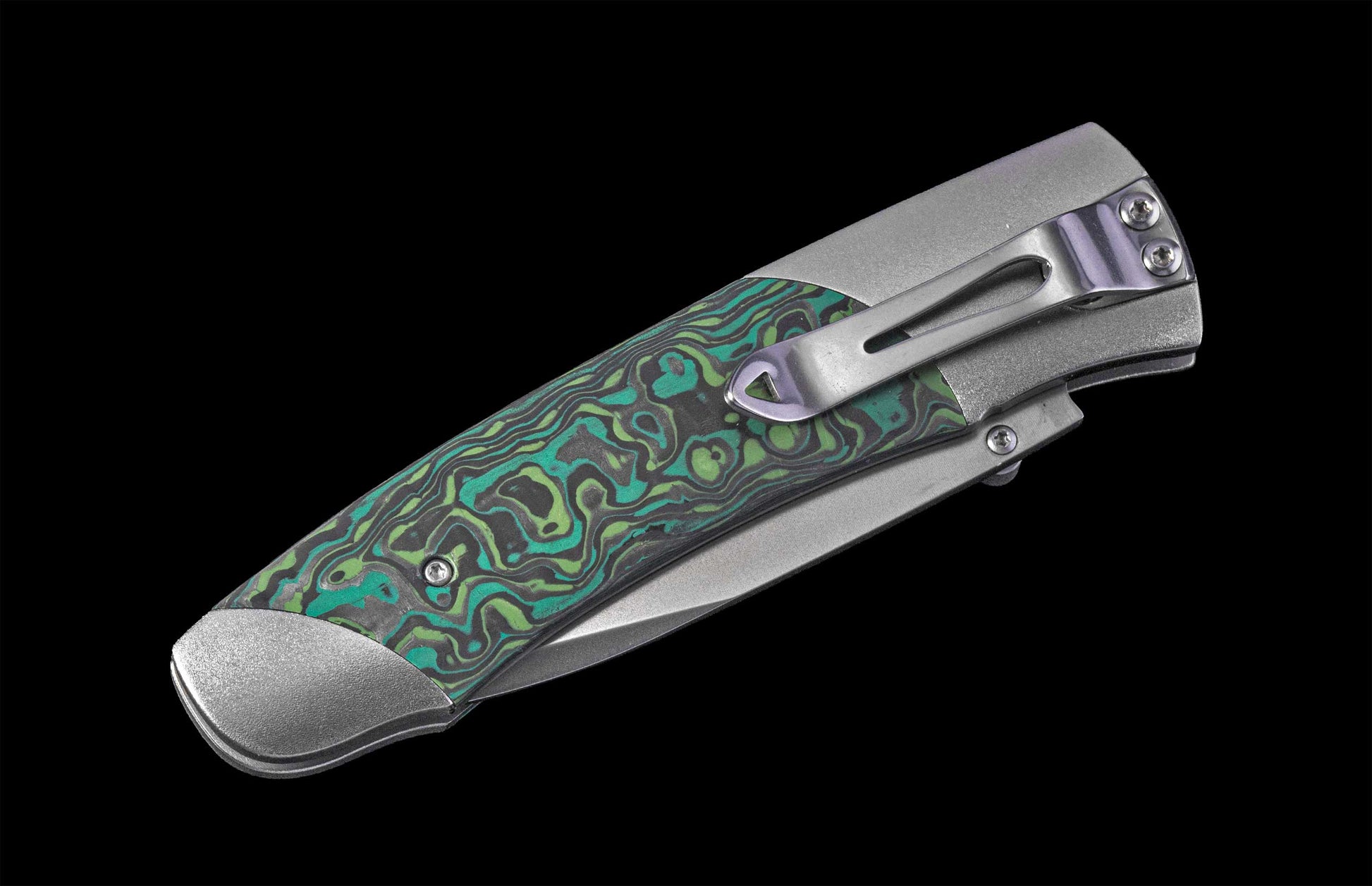 Foldable knife with green patterned handle on a black background