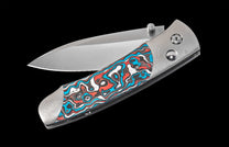 Folding knife with a colorful handle on a black background