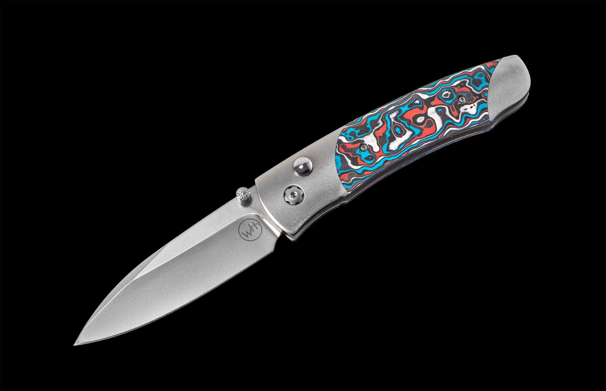 Folding knife with decorative handle on a black background