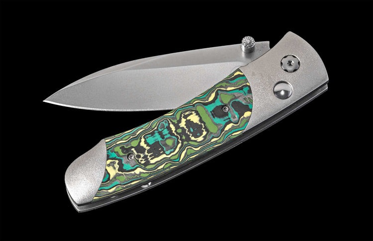 Folding knife with a decorative handle on a black background