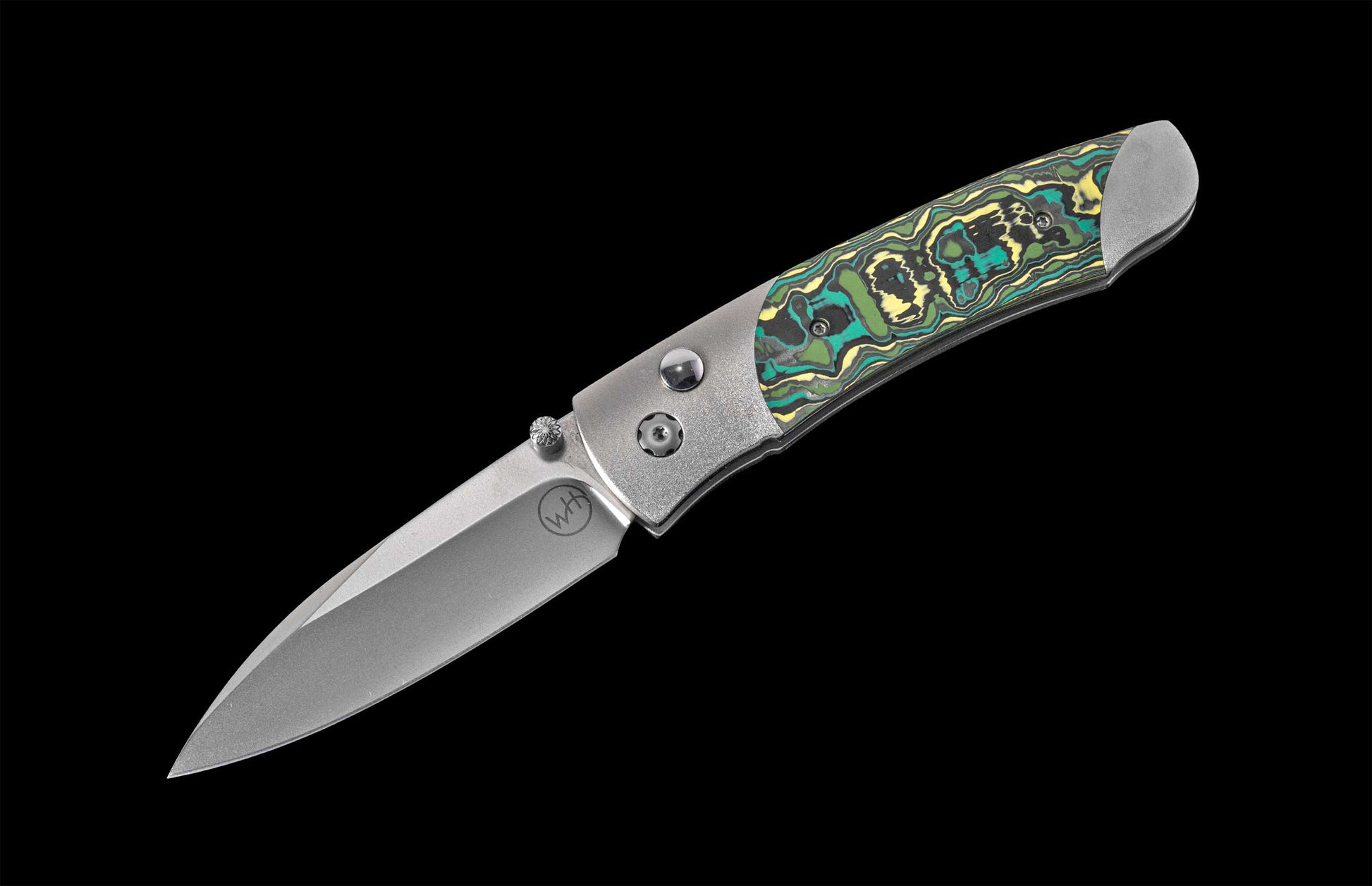 Folding knife with a decorative handle on a black background