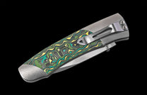 Folding knife with a decorative handle on a black background