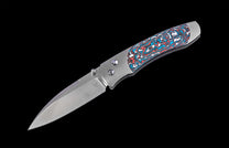 Folding knife with a decorative handle on a black background