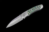 Folding knife with decorative handle on a black background