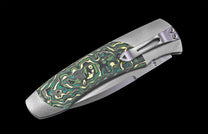 Folding knife with decorative handle on a black background