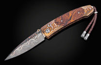 Folding knife with decorative handle and blade on a black background