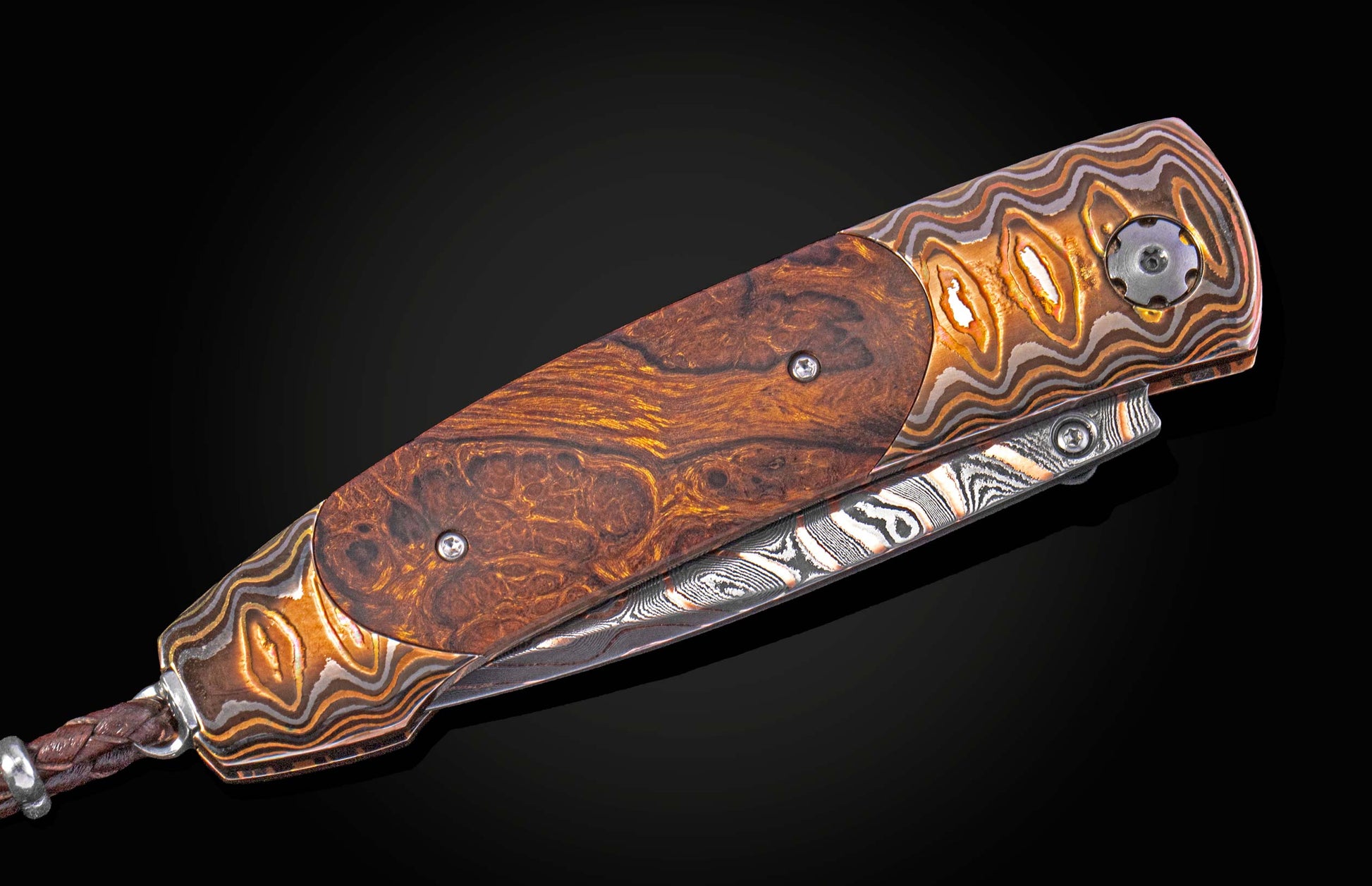 Folding knife with decorative handle and blade on a black background
