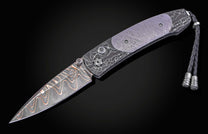 William Henry folding knife with Damascus steel blade  and frame with  Gibeon meteorite scales on a black background