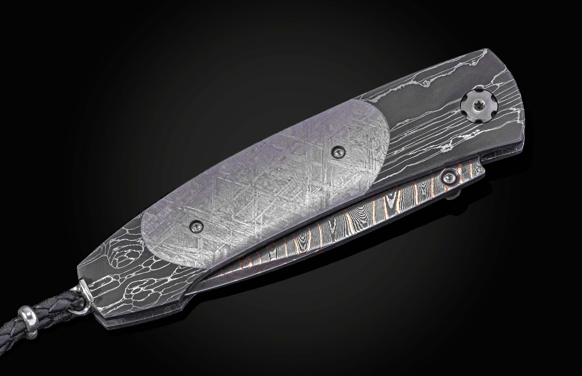 William Henry folding knife with Damascus steel blade  and frame with  Gibeon meteorite scales on a black background