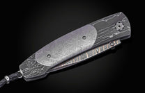 William Henry folding knife with Damascus steel blade  and frame with  Gibeon meteorite scales on a black background