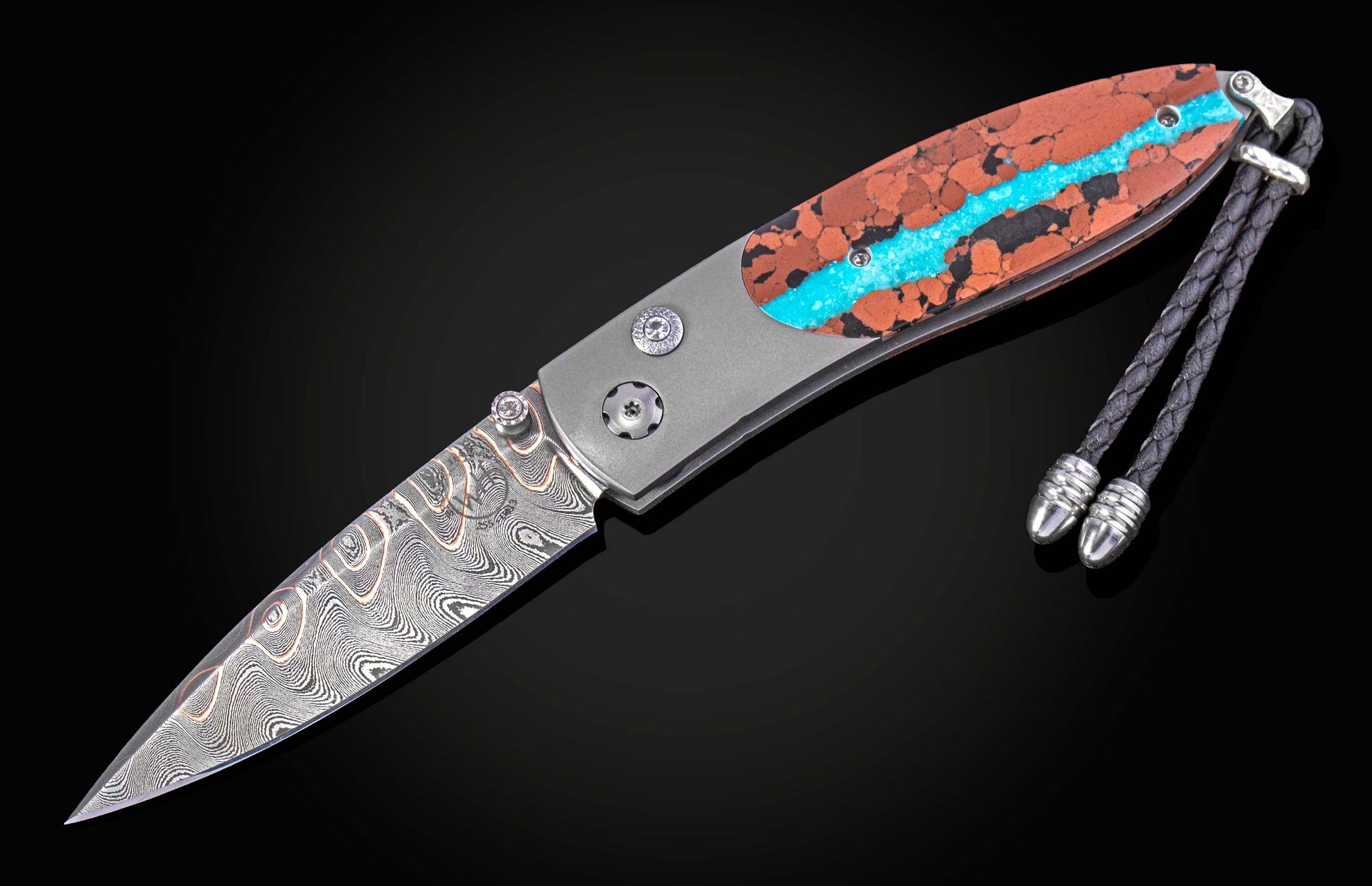 William Henry knife inlaid with vein turquoise and lava rock with damascus blade.