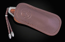 Folding knife with wooden handle and damascus blade on a black background