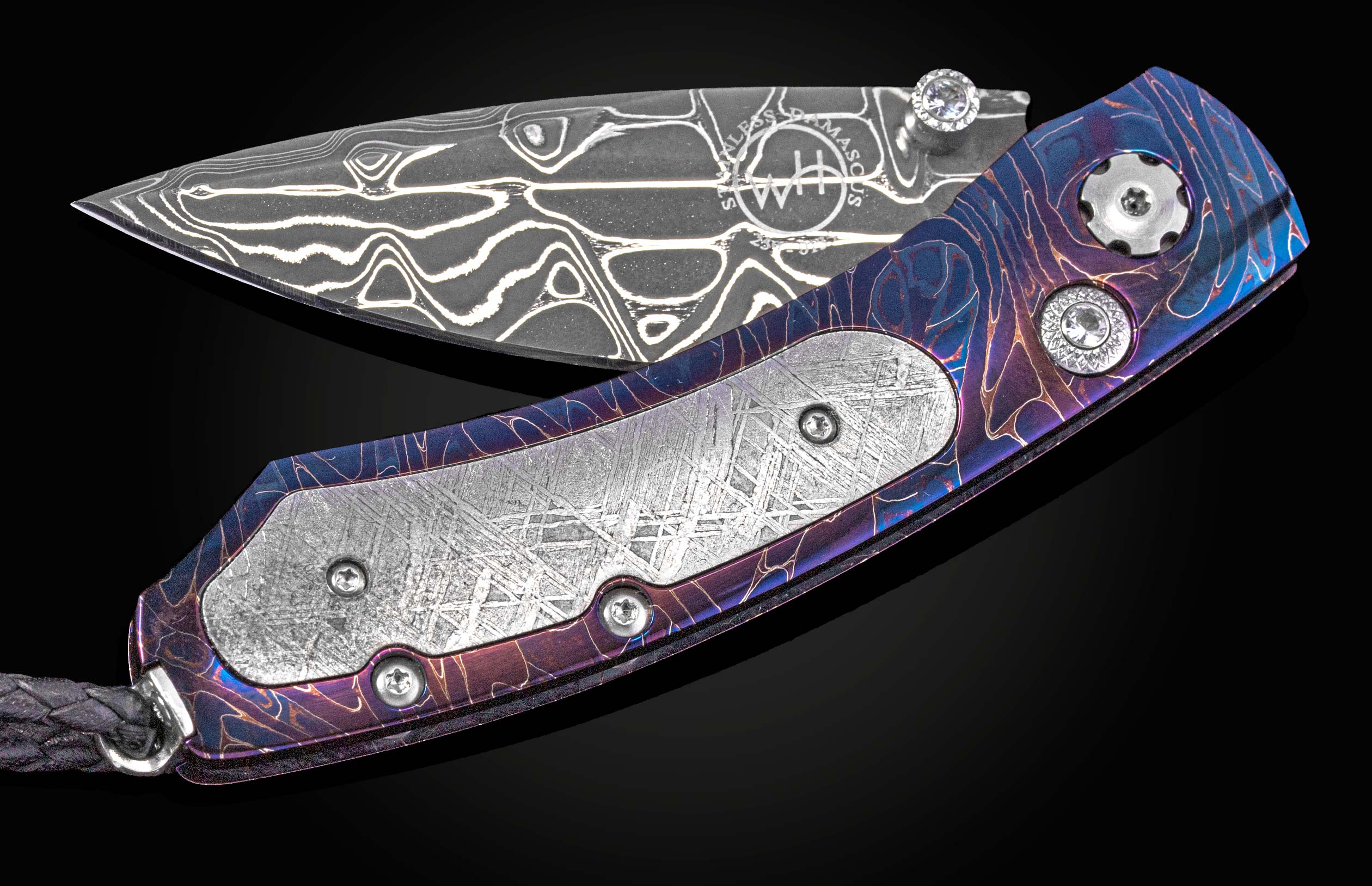 Folding knife with decorative handle and blade on a black background