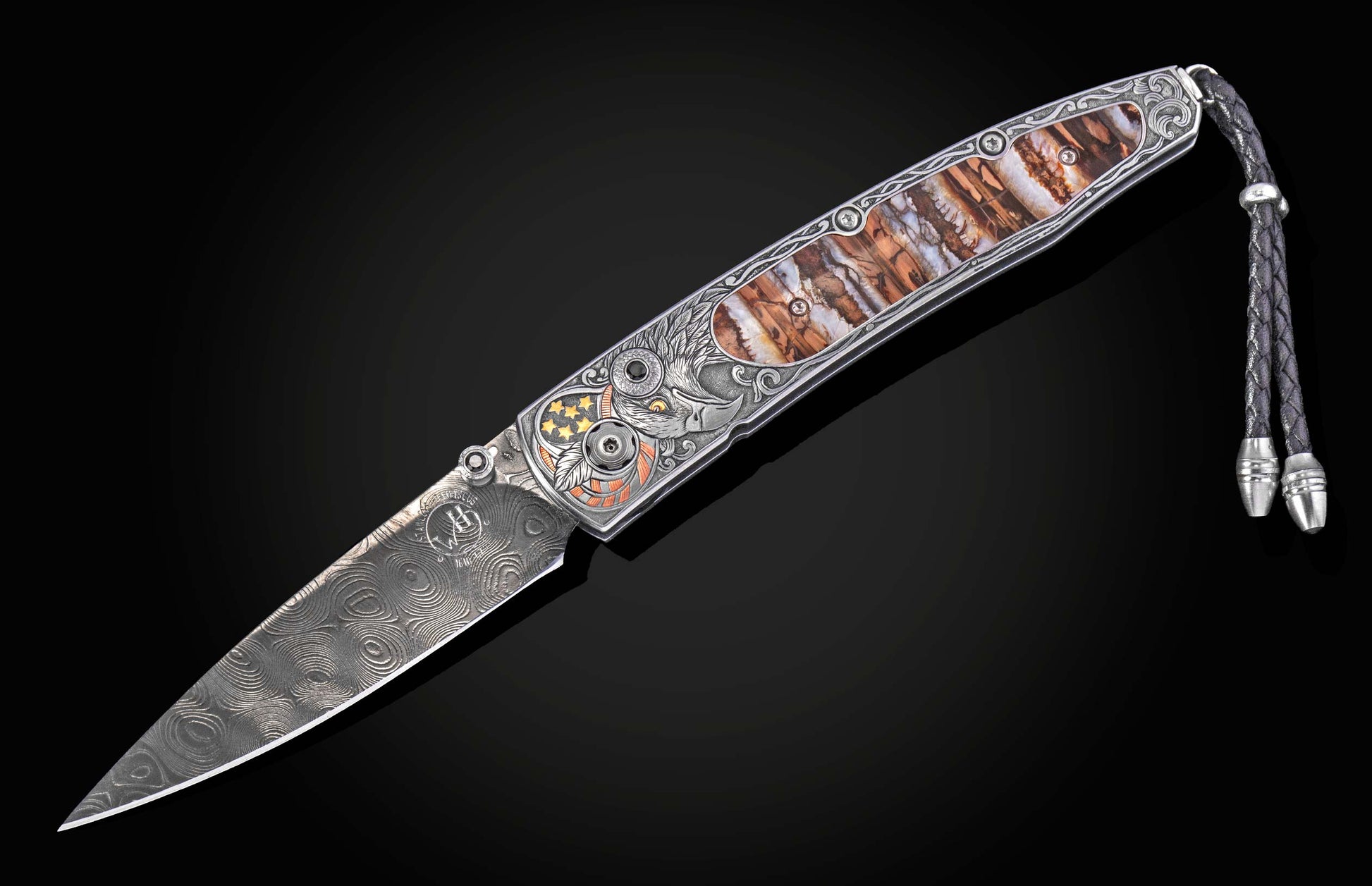 Damascus steel knife with intricate eagle engraving and wood inlay, by B10, featuring braided lanyard and detailed silver handle, side view