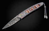 Damascus steel knife with intricate eagle engraving and wood inlay, by B10, featuring braided lanyard and detailed silver handle, side view