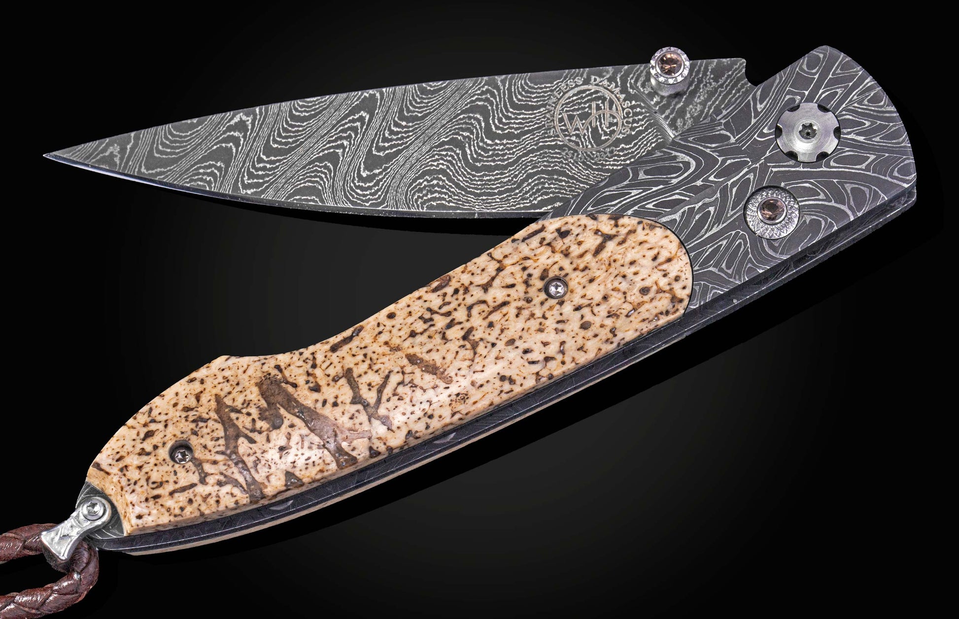 Folding knife with damascus blade and fossil walrus bone scales on a black background