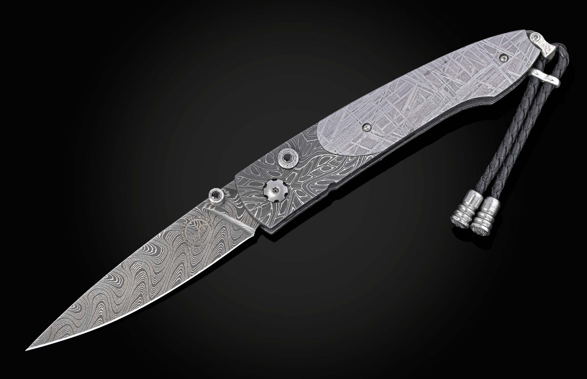 Decorative knife with damascus blade and meteorite handle on a black background shown open