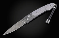 Decorative knife with damascus blade and meteorite handle on a black background shown open
