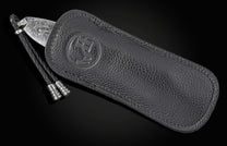 Black leather sheath with a knife on a black background