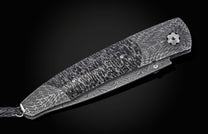 Damascus steel folding knife with wavy pattern and textured handle, side view on black background