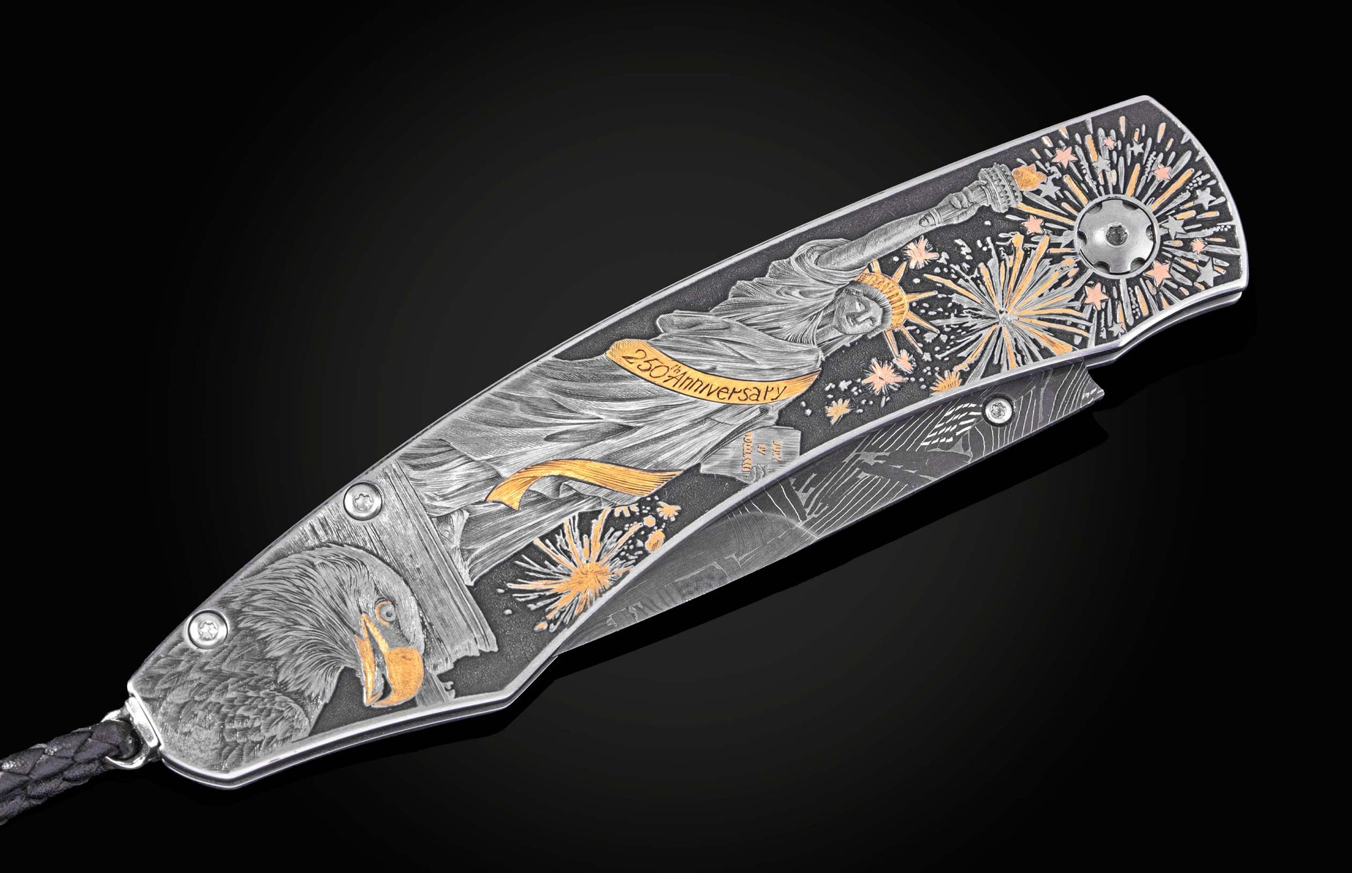 Silver folding knife with engraved Statue of Liberty and fireworks, by B12, featuring gold accents and eagle detail, side view on black background