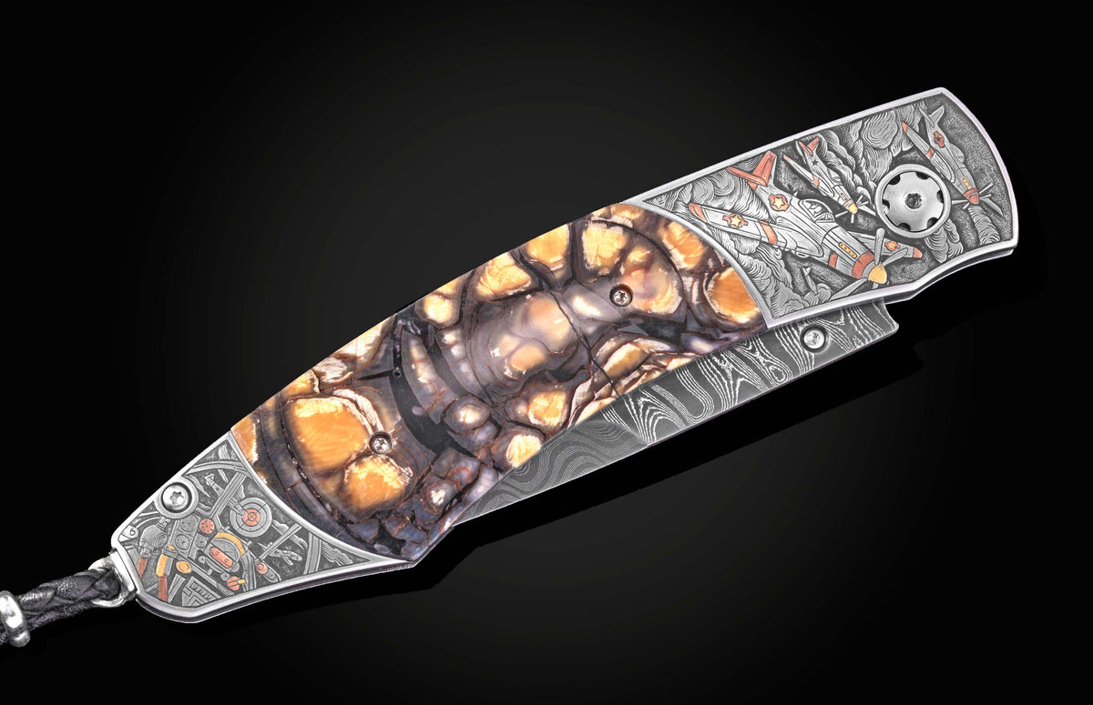 Luxury folding knife with amber-streaked mosaic handle and engraved P51 Mustang artwork, side view on black background