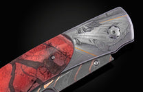 A folding knife with a red and black cracked handle, featuring a detailed engraved 1963 Split Window Corvette on the metal frame.