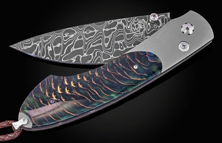Damascus steel blade with intricate wave pattern and iridescent pinecone-textured handle by B12, side view on black background