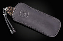 Black leather knife sheath with embossed logo and braided cord, side view, luxury finish
