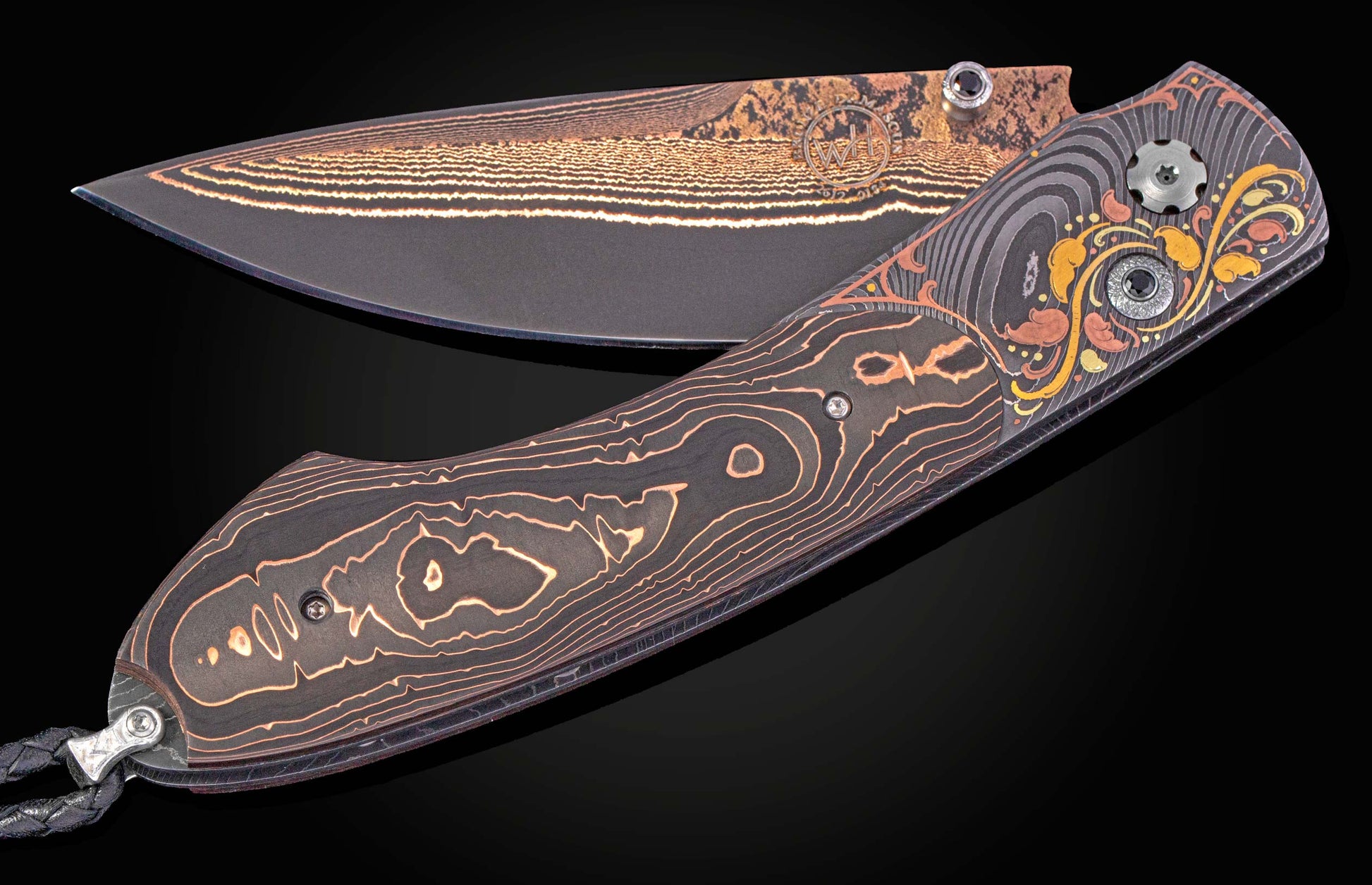 Dark folding knife with ornate golden leaf patterns on the handle and layered gold lines on the blade, featuring dark faceted stones.