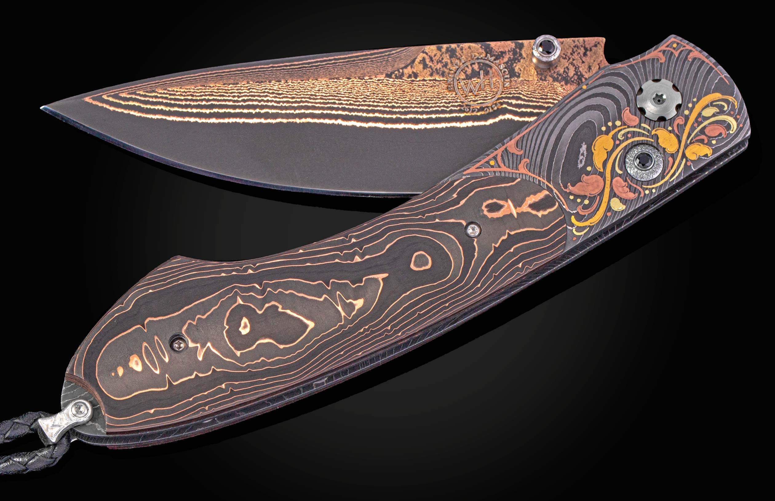 Dark folding knife with ornate golden leaf patterns on the handle and layered gold lines on the blade, featuring dark faceted stones.
