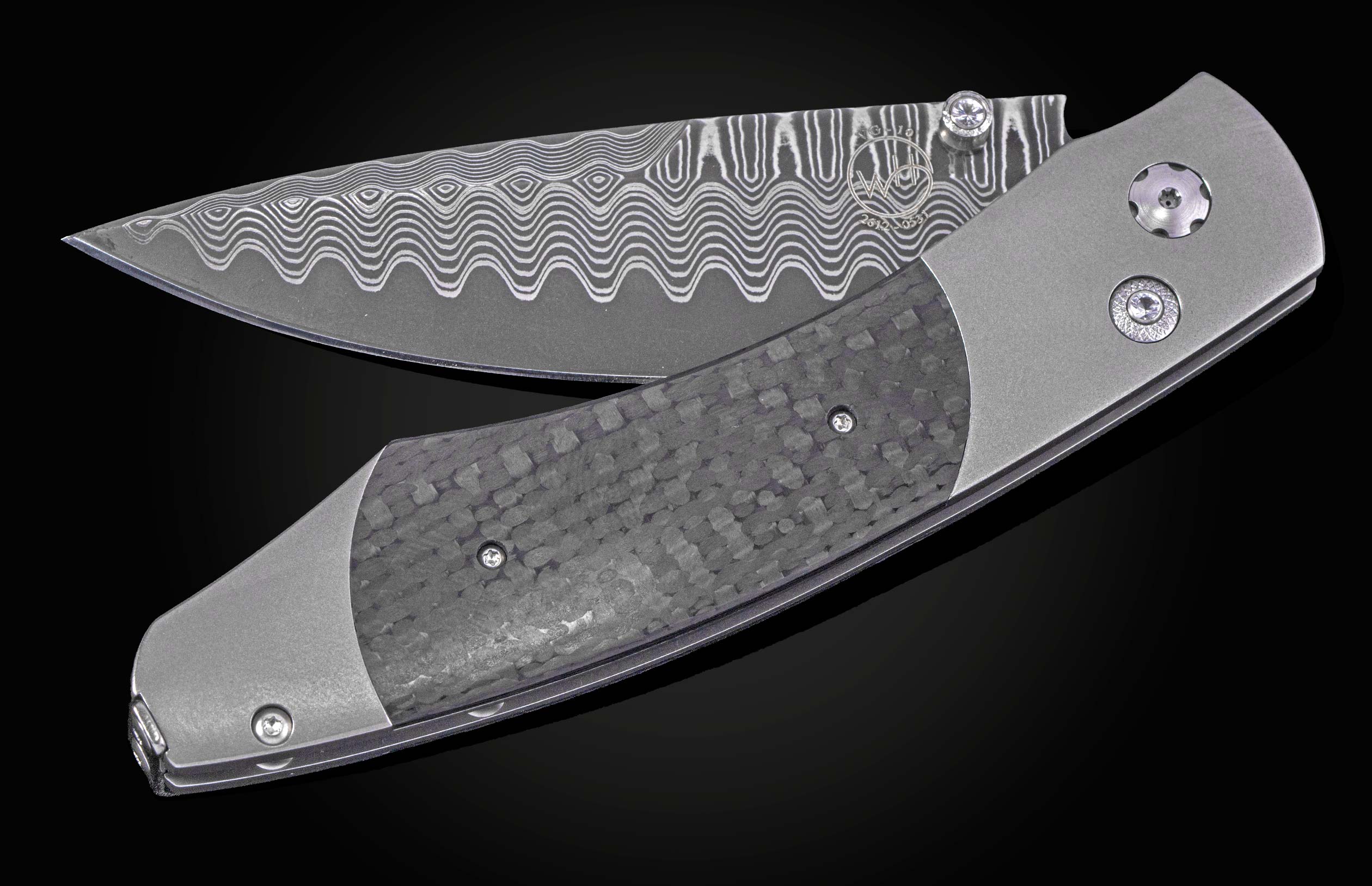 Folding knife with a dark, textured carbon fiber handle, grey titanium frame, and wavy patterned Damascus blade, partially open on a black background.