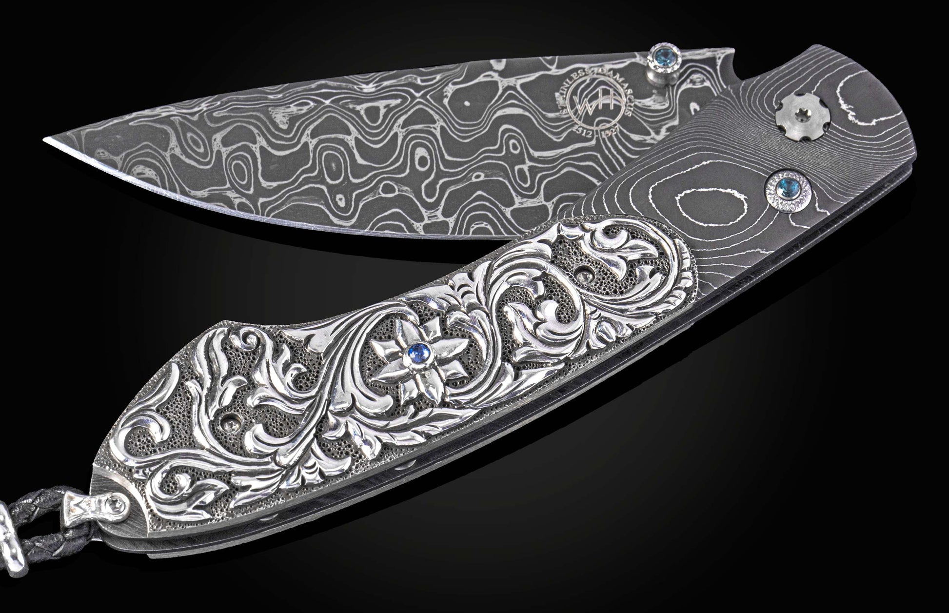 William Henry knife with hand carved sterling silver scales and damascus steel.