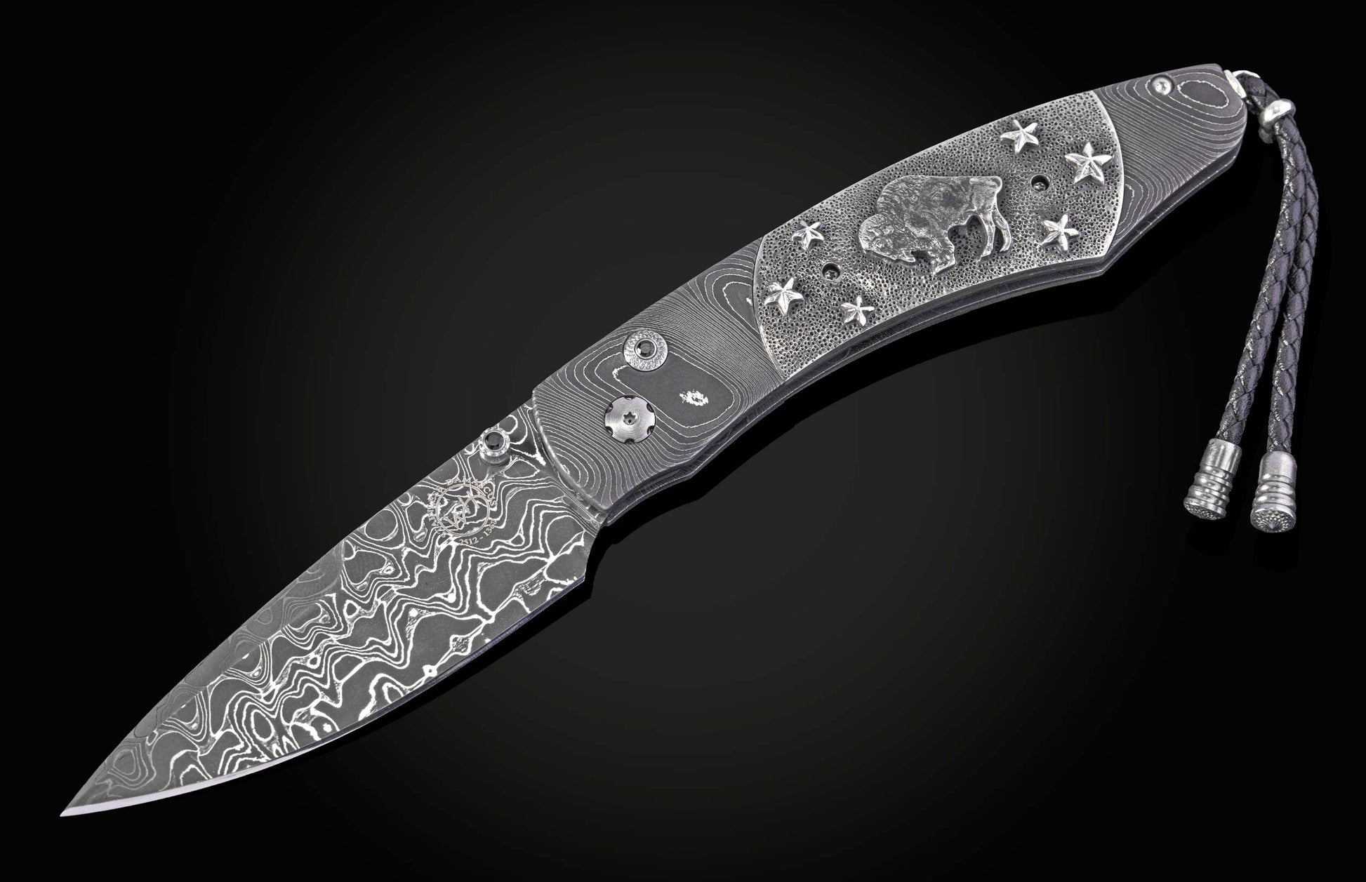 William Henry folding knife with damascus steel and hand carved sterling silver buffalo design