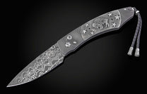 William Henry folding knife with damascus steel and hand carved sterling silver buffalo design