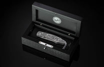 William Henry folding knife with damascus steel and hand carved sterling silver buffalo design