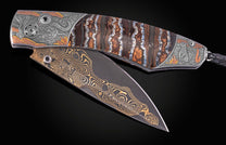 Decorative knife with intricate patterns on a dark background