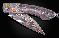 Hand engraved knife with Damascus steel blade on a black background