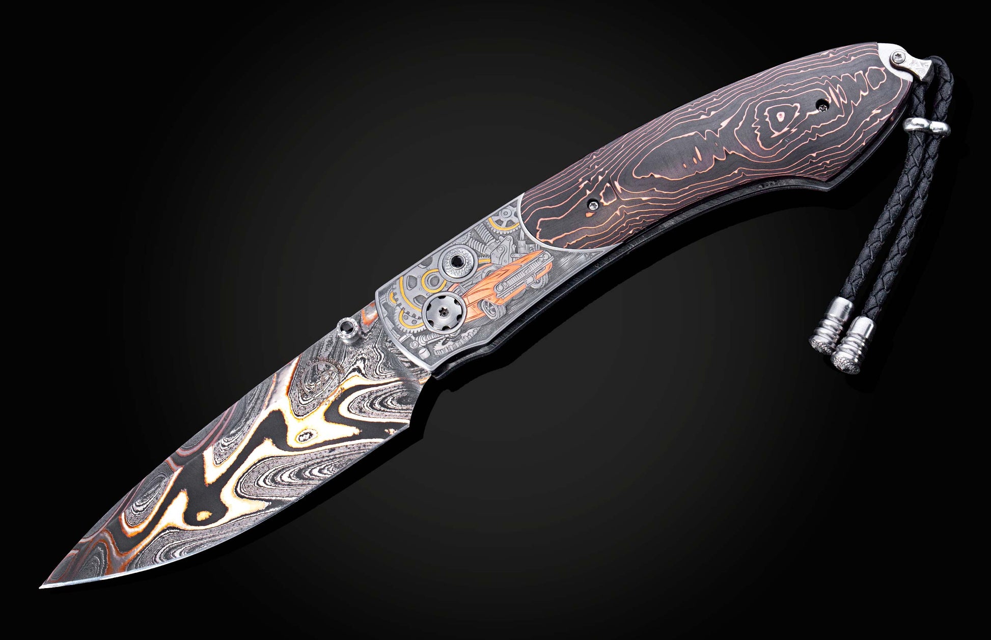 Hand engraved knife with Damascus steel blade on a black background