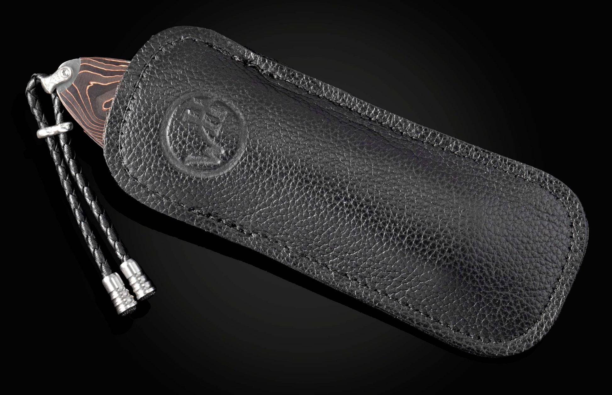 Hand engraved knife with Damascus steel blade on a black background