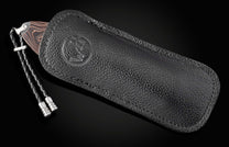 Hand engraved knife with Damascus steel blade on a black background