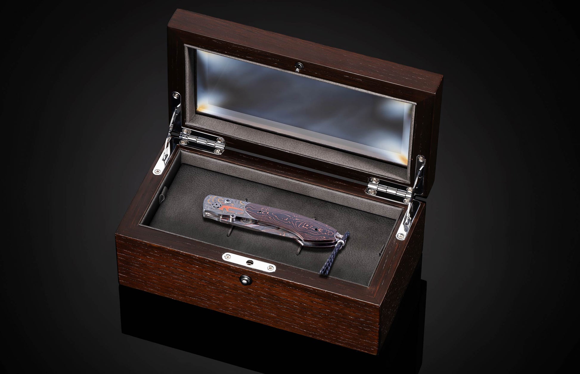 Hand engraved knife with Damascus steel blade on a black background