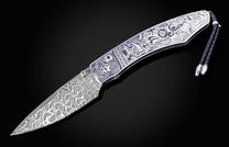 Decorative knife with intricate patterns on a dark background